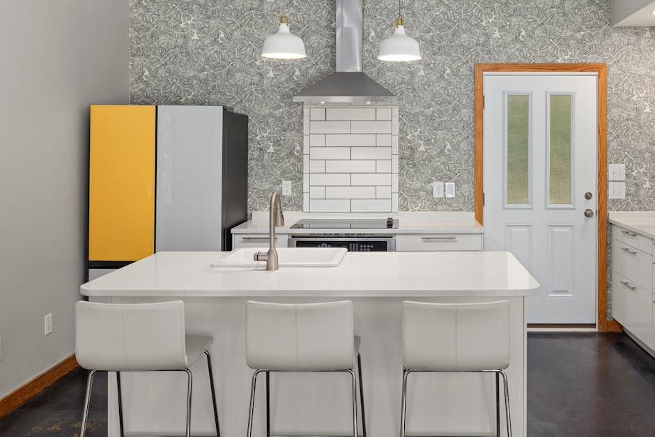 Contemporary kitchen featuring an island, pendant lights, and modern appliances.